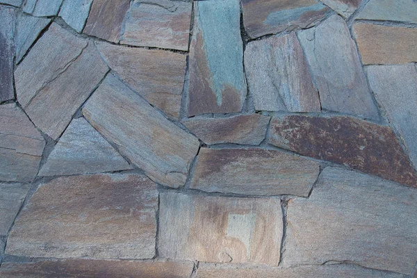 Background texture of a stone wall. A stone wall or pavement. A stone-paved path. — Stock Photo, Image