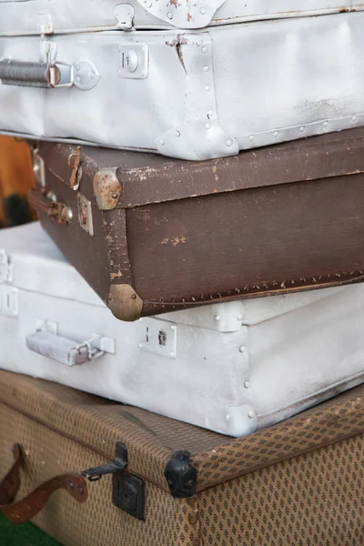 Vintage weathered leather and metal suitcases on top of each other. Retro. Background — Stock Photo, Image