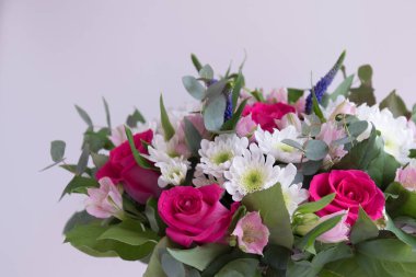 Arka plan olarak pembe güller ve beyaz kasımpatılar. Buket yakın plan. Kartpostal, arkaplan.