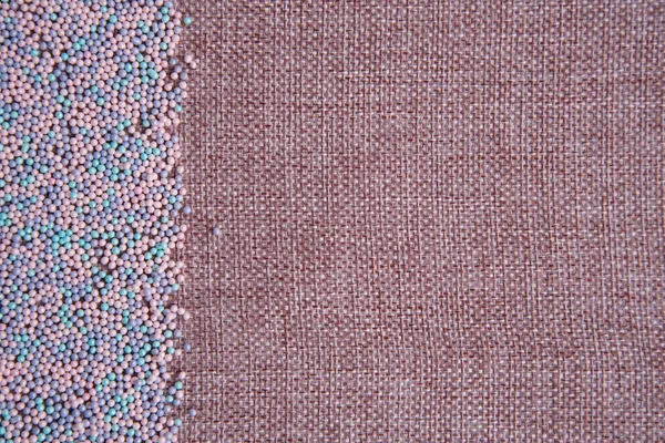 Background of linen yarn, burlap. On one side, the card is decorated with pastry topping. All in pink and blue shades. Sweet — ストック写真