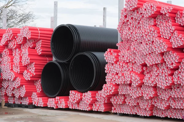 A lot of plastic pipes. Pipes of various colors and sizes. Warehouse, production