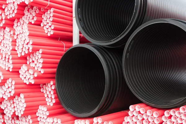 A lot of plastic pipes. Pipes of various colors and sizes. Warehouse, production