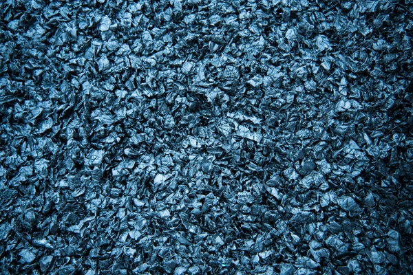 Particles of crushed plastic are black in color. Plastic before melting. The concept of caring for the environment.