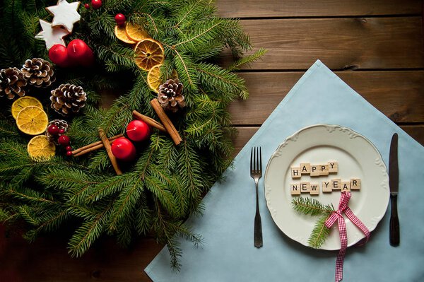 Творческая рождественская композиция с венком и таблицей со словами: С Новым годом. Необычная идея для декора дома отдыха в винтажном стиле. Естественный интерьер на деревянном фоне. Плоский лежал
