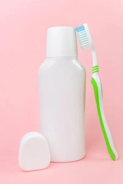 White Mouthwash Bottle Toothbrush Dental Floss Package Pastel Pink Background — Stock Photo, Image