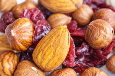 Soyulmuş badem, fındık ve kurutulmuş kiraz yakından. Fındık makro fotoğrafı. Sağlıklı gıda ve vejetaryenlik kavramı.