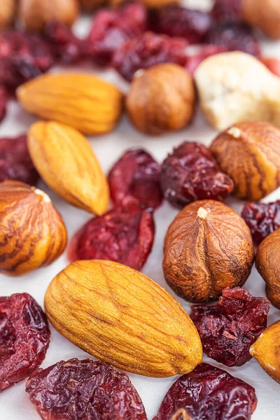 Peeled almonds, hazelnuts and dried cherries closeup. Macro photo of nuts. The concept of healthy food, vegetarianism.