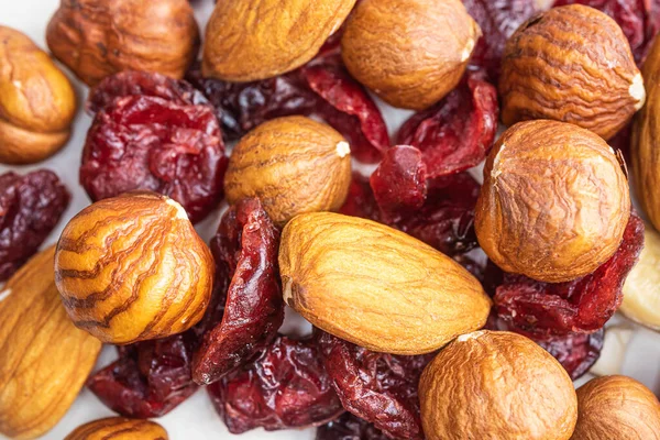 Peeled almonds, hazelnuts and dried cherries closeup. Macro photo of nuts. The concept of healthy food, vegetarianism.