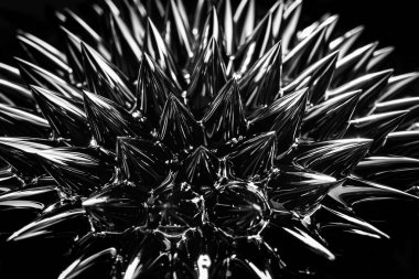 Ferrofluid, magnetic fluid close-up. Abstract minimalistic black trendy background. Fluid highly polarized in the presence of a magnetic field. Impressive, stylish iridescent black spikes. clipart
