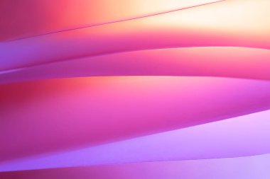 Makro fotoğraf. Soyut minimalist arka plan - kağıt sanatı. Neon pembe, sarı ve mavi ışık, minimalizm, kopyalanma alanı. Dalgalar, kağıt kesiği. 3B etkisi.