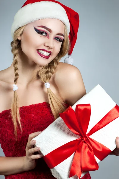 Closeup winter portrait of girl in santa hat. Bright creative makeup. Positive emotions — Stock Photo, Image