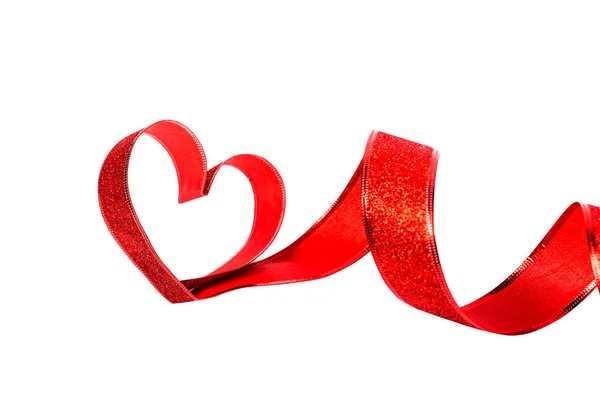 Red ribbon shaped as hearts on white — Stock Photo, Image