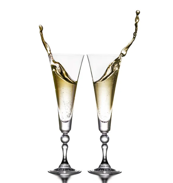 Two glasses on a white background. Glasses of champagne. Splash. — Stock Photo, Image