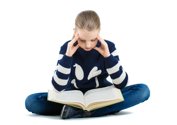 Thoughtful girl sitting on the floor with a book. girl holding hands near head. — Stock Photo, Image