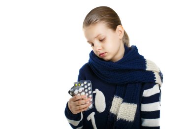 sad girl in a warm sweater and scarf holding a tablet in hands clipart