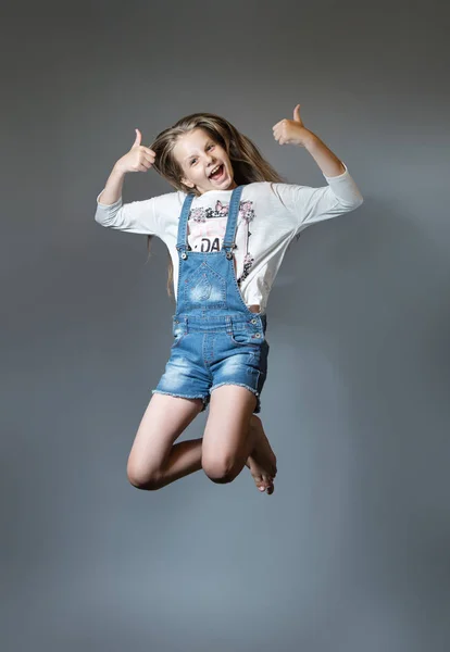 Lovely girl joyfully jumping Stock Picture