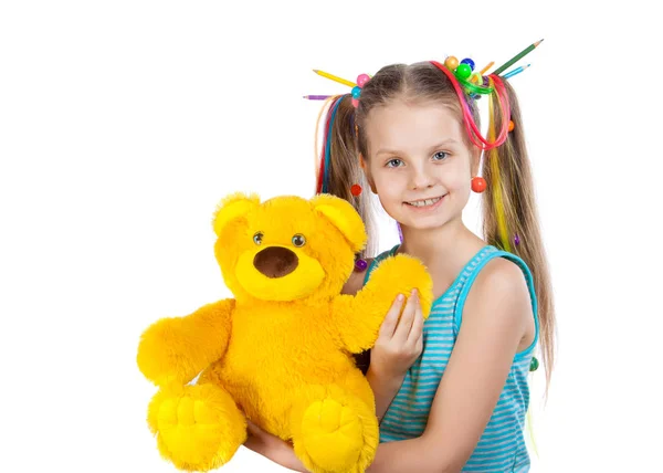 Retrato de una chica divertida con hebras de colores en el pelo. Lápices de colores, cuentas, mechones de pelo de colores en su cabello. niña sosteniendo un juguete oso amarillo — Foto de Stock