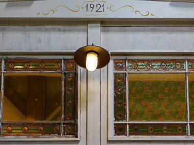 An old window from 1921 with a lantern clipart