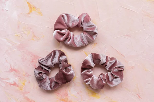 Three trendy velvet scrunchies on pink background — Stock Photo, Image