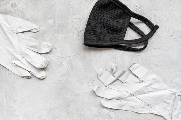 Máscara de algodón negro y guantes de goma médica —  Fotos de Stock