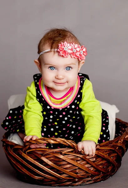 Baby girl in flower basket — Stock Photo, Image