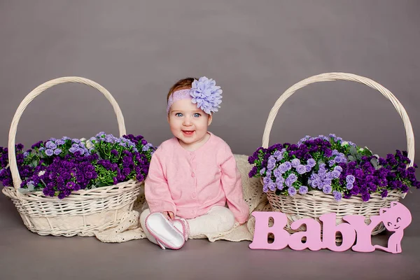 Baby girl in flower basket — Stock Photo, Image