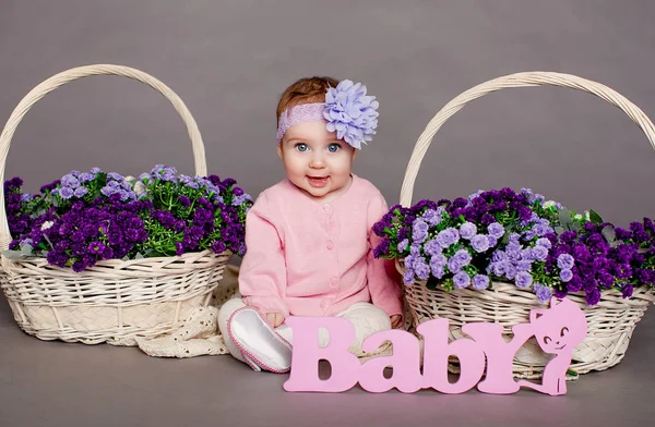 Baby girl in flower basket — Stock Photo, Image