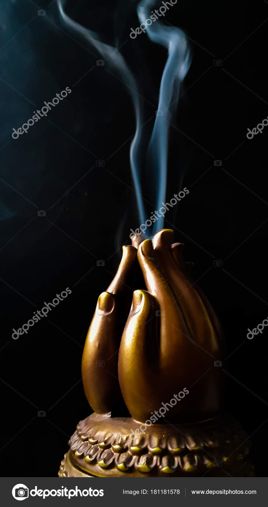 Incense smoke from burning in wooden prayer hands Stock Photo by ©janecat11 181181578