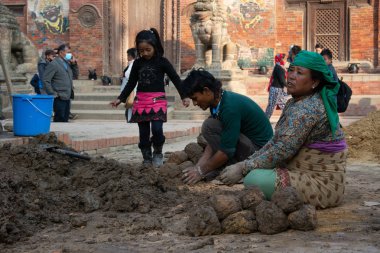 Katmandu, Nepal - 26 Kasım 2016: Patan Durbar Meydanı 'ndaki bir miras alanının yeniden inşasında kullanılacak kilden topları hazırlayan inşaat işçileri.
