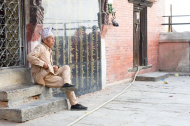 Kathmandu, Nepal - 3 Haziran 2017: Yaşlı yetişkin, Kirtipur 'daki Bagh Bhairav tapınağında dinleniyor.