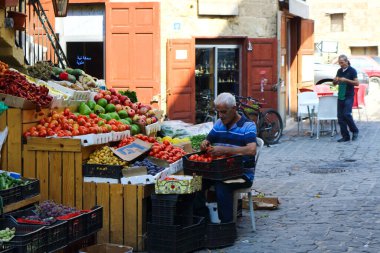 Batroun, Lübnan - 15 Ekim 2017: Eski kasaba bölgesindeki sebze dükkanının önünde oturan esnaf.
