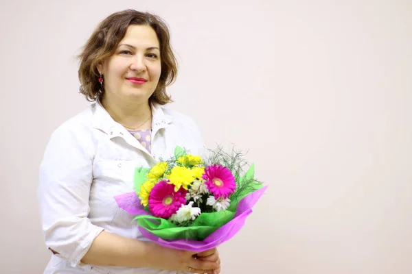 A doctor with a bouquet of flowers