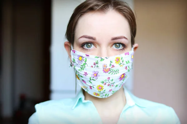 Female face in a designer medical mask against viruses