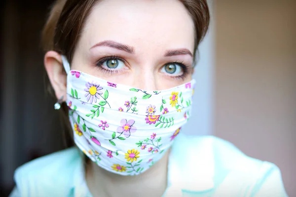 Female face in a designer medical mask against viruses