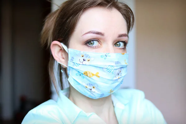 Female face in a designer medical mask against viruses