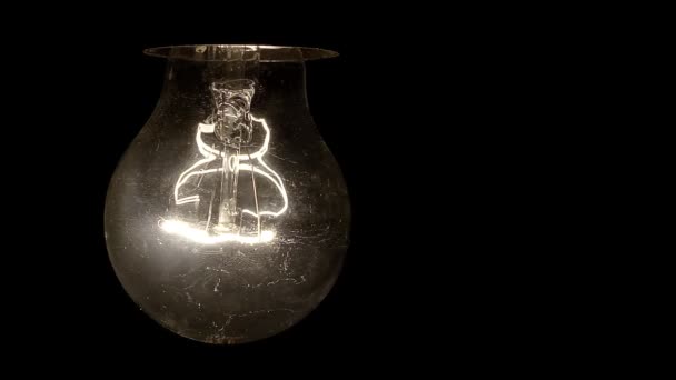 Glowing hanging light bulb dangle on a wire loop 4K — Stock Video