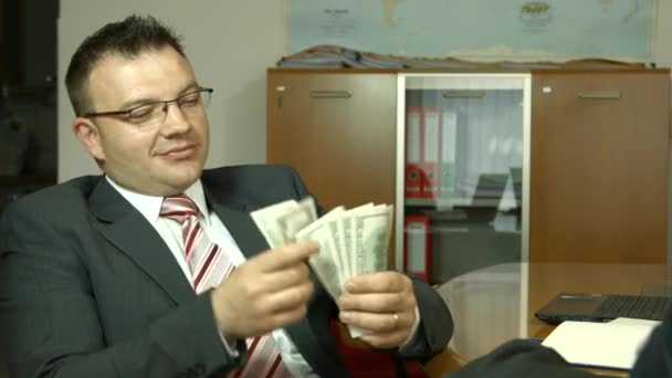 Cheerful banker showing his dividend profit, income, earnings, gain, benefit — ストック動画