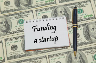 Doları arka plan üzerinde bir başlangıç finansman metin ile defter sayfası