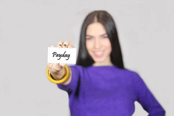 Female holding business card with message PAYDAY — Stock Photo, Image
