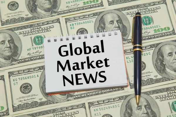 Notebook with text GLOBAL MARKET NEWS on dollar background