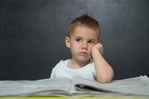 Little boy  like businessman in office with newspaper and cellphone — Stock Photo, Image