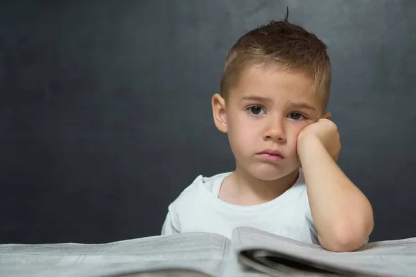 Little boy  like businessman in office with newspaper — Stock Photo, Image