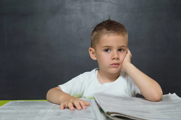 Little boy  like businessman in office with newspaper — Stock Photo, Image