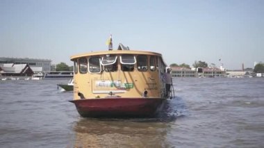 BANGKOK, THAILAND 19 ARALIK 2019: Bangkok 'taki Chao Phraya Nehri' ndeki kamu botu yolcularla birlikte rıhtıma yanaşıyor.