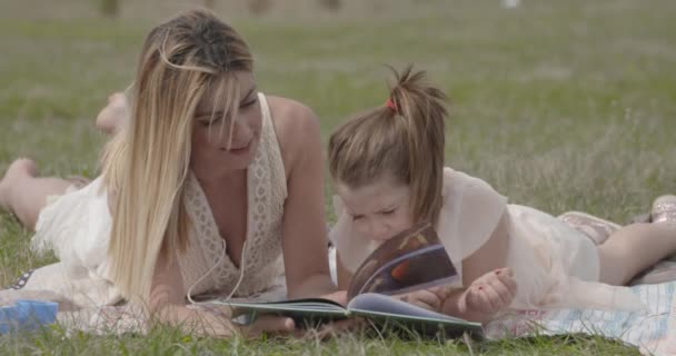 Young Beautiful Mother Her Daughter Having Fun Nature Park Reading — Stock Video