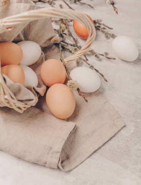 Sepette Paskalya yumurtaları ve gri arka planda söğüt dalları