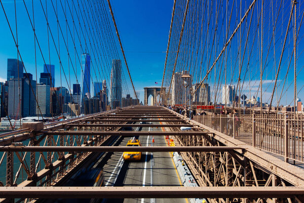 Spring April 2015 Brooklyn Bridge Traffic with yellow cab and people, New York United States