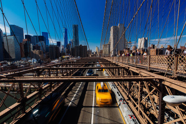 Spring April 2015 Brooklyn Bridge Traffic with yellow cab and people, New York United States