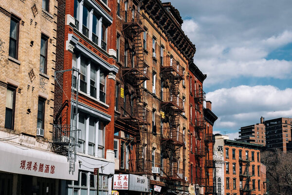 New York City - USA - Mar 19 2019: Typical brick buildings of Chinatown with sings in Lower Manhattan