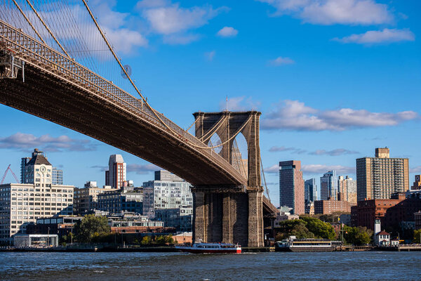 New York City - USA - Oct 18 2019: Brooklyn Bridge in daylight view from Lower East Side waterfront